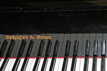 Piano with some key and reflection from lid